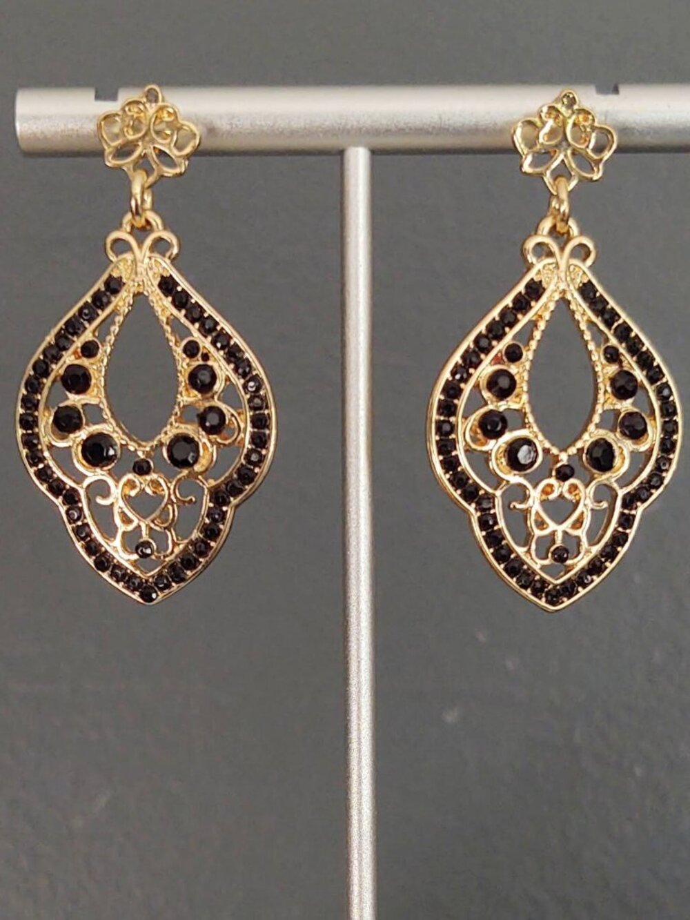 Open design gold and black earrings